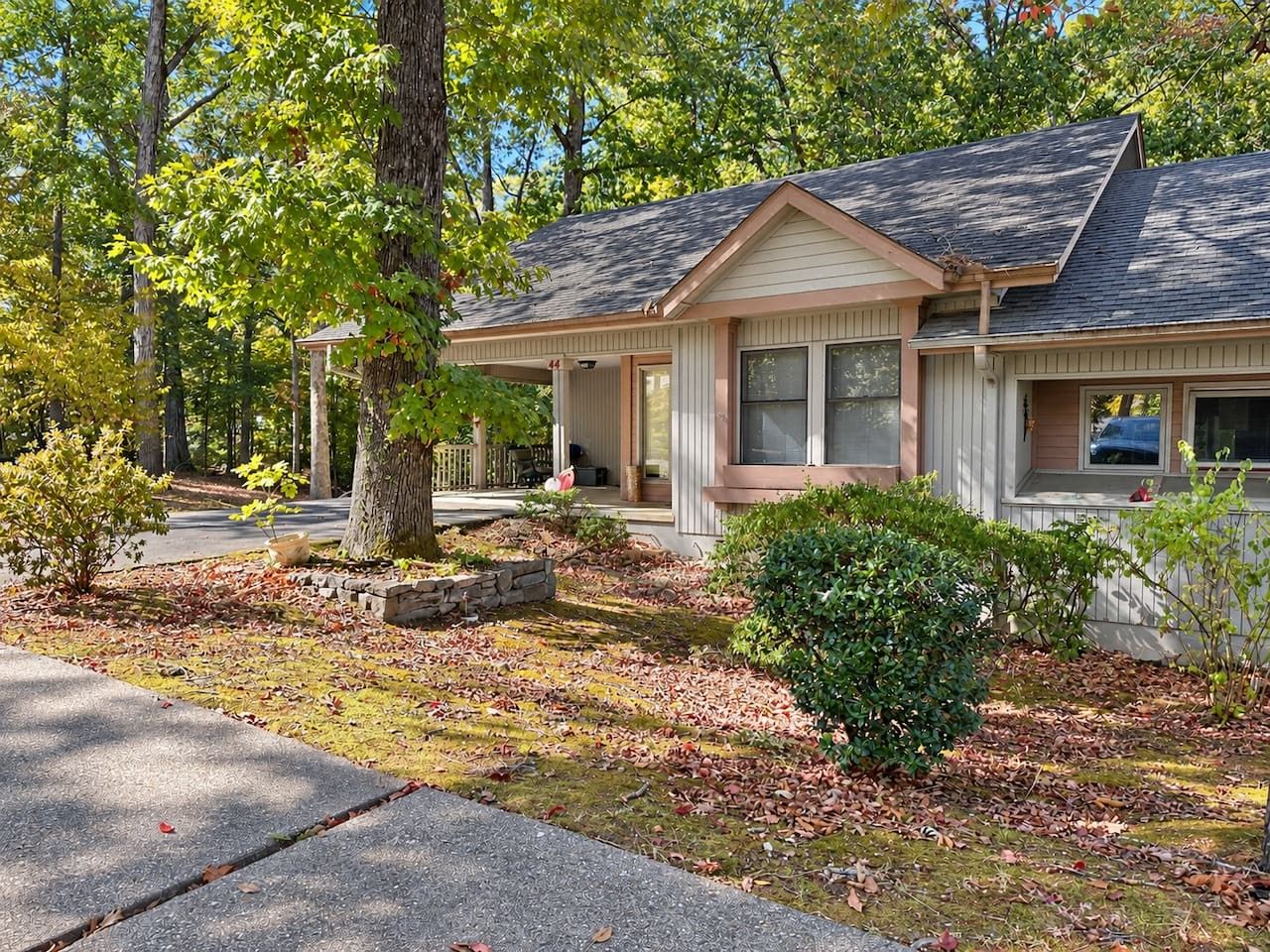 A single-story house with a front porch, a garage, and a well-maintained lawn.