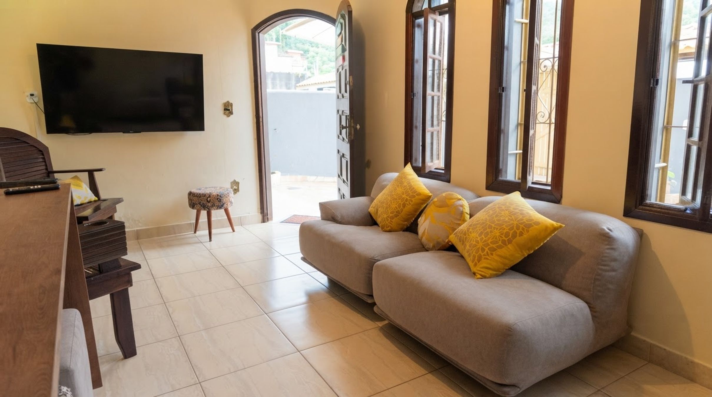 A living room with a sofa, a television, and a small table.
