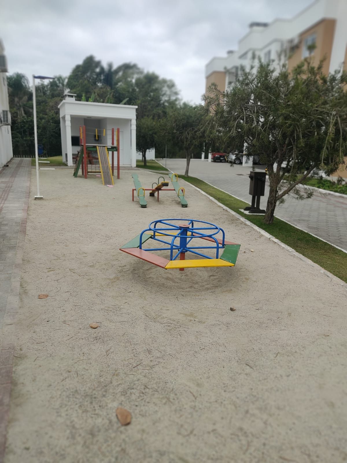 A playground with a swing set and a climbing structure.