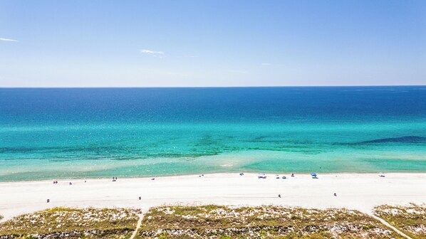 A beach with clear turquoise waters and a sandy shore. - Laguna Matata • 5BR • Private Pool • Gulf Views • Hot Tub (Panama City Beach)