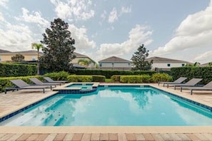 A swimming pool with lounge chairs and a clear sky. - ECR641 - Stunning Dream Vacation+Theater @Encore (Kissimmee)