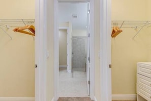 A hallway with a white door leading to a bathroom. There are two towel racks with towels hanging on them. - ECR641 - Stunning Dream Vacation+Theater @Encore (Kissimmee)