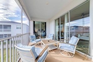 A balcony with a seating area, including chairs and a table, overlooking a residential area. - Resort Access Vacation Retreat! | CG9327 (Davenport)