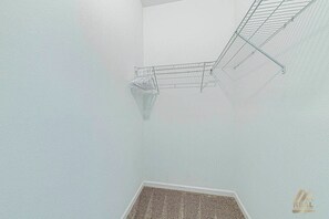 A corner of a room with a white wall, a metal drying rack, and a carpeted floor. - CG9327 - 3B Resort Access Vacation Retreat (Davenport)