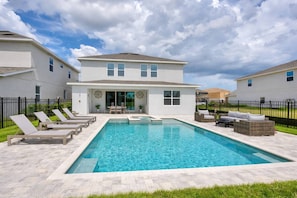 A modern two-story house with a swimming pool, outdoor seating, and a well-maintained lawn. - ECR7676 - Bright Villa @Encore close from Disney! (Kissimmee)