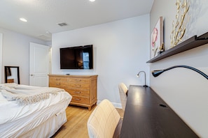 A bedroom with a bed, dresser, TV, and a desk with a lamp. - ECR7609 - Enchanted Vacation Home @Encore (Kissimmee)