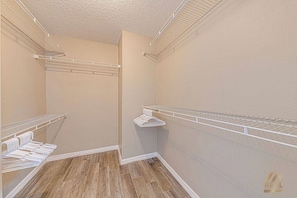 A walk-in closet with metal shelving units and a wooden floor. - RVH228 - Cozy Home with Pool, 3B Near Disney (Davenport)
