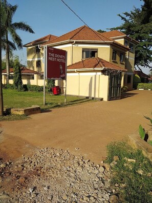 A two-story building with a sign for 'The Dove's Nest Hotel'. - The Dove's Nest Hotel Gulu (Gulu)