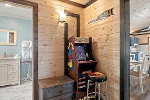 An arcade game adds another fun option when your group is ready for some downtime at home. - 2 Miles to GSMNP- Hot Tub, Mtn Views, Fire Pit & Dog- Friendly + Fenced Dog Run (Sevierville)