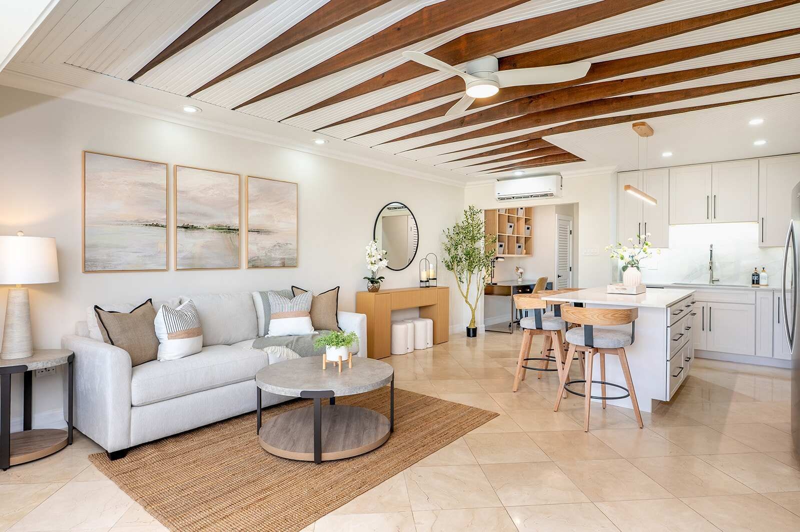 A modern living room with a sofa, coffee table, and artwork on the wall.