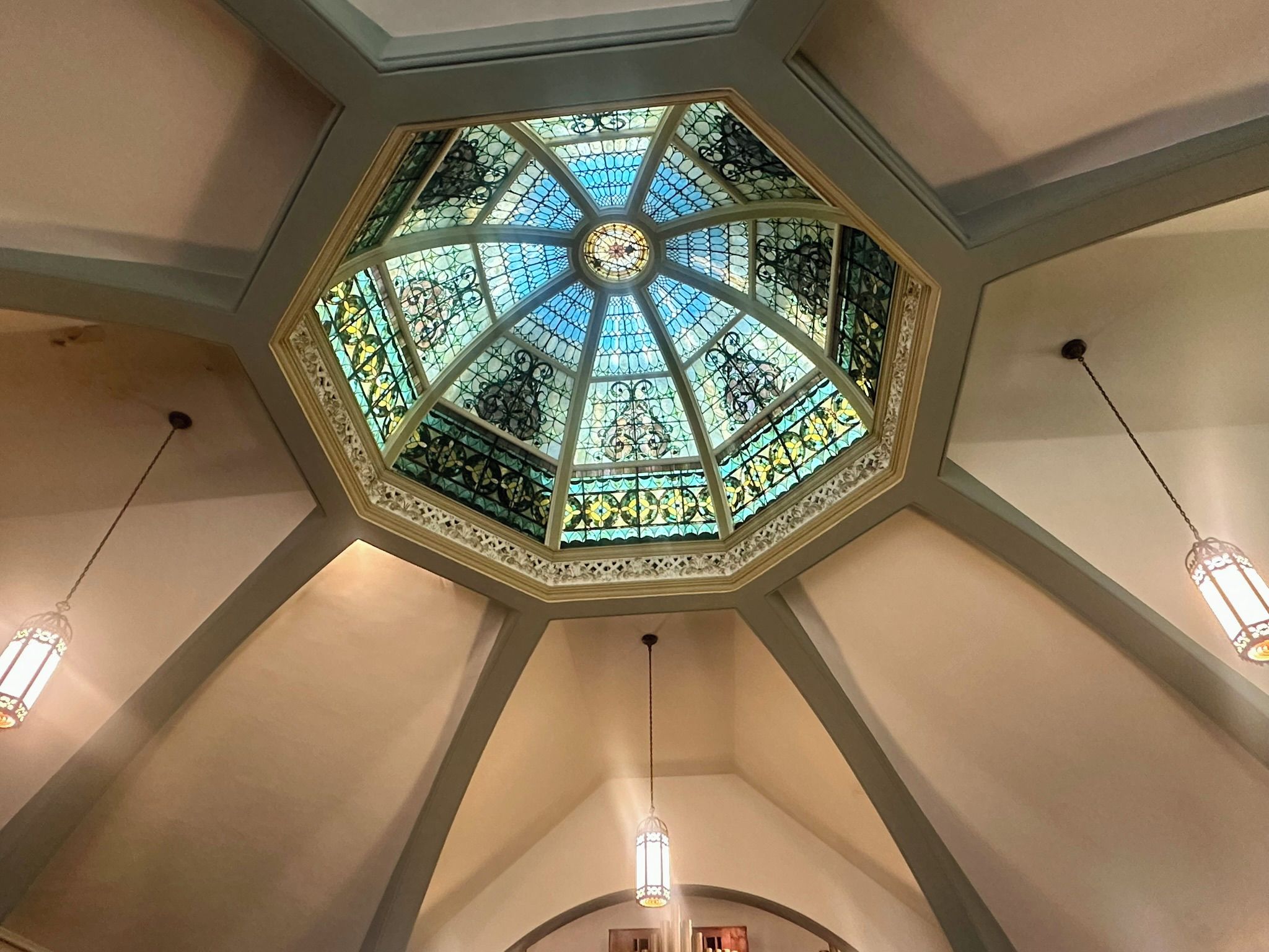 A hexagonal skylight with intricate stained glass design.