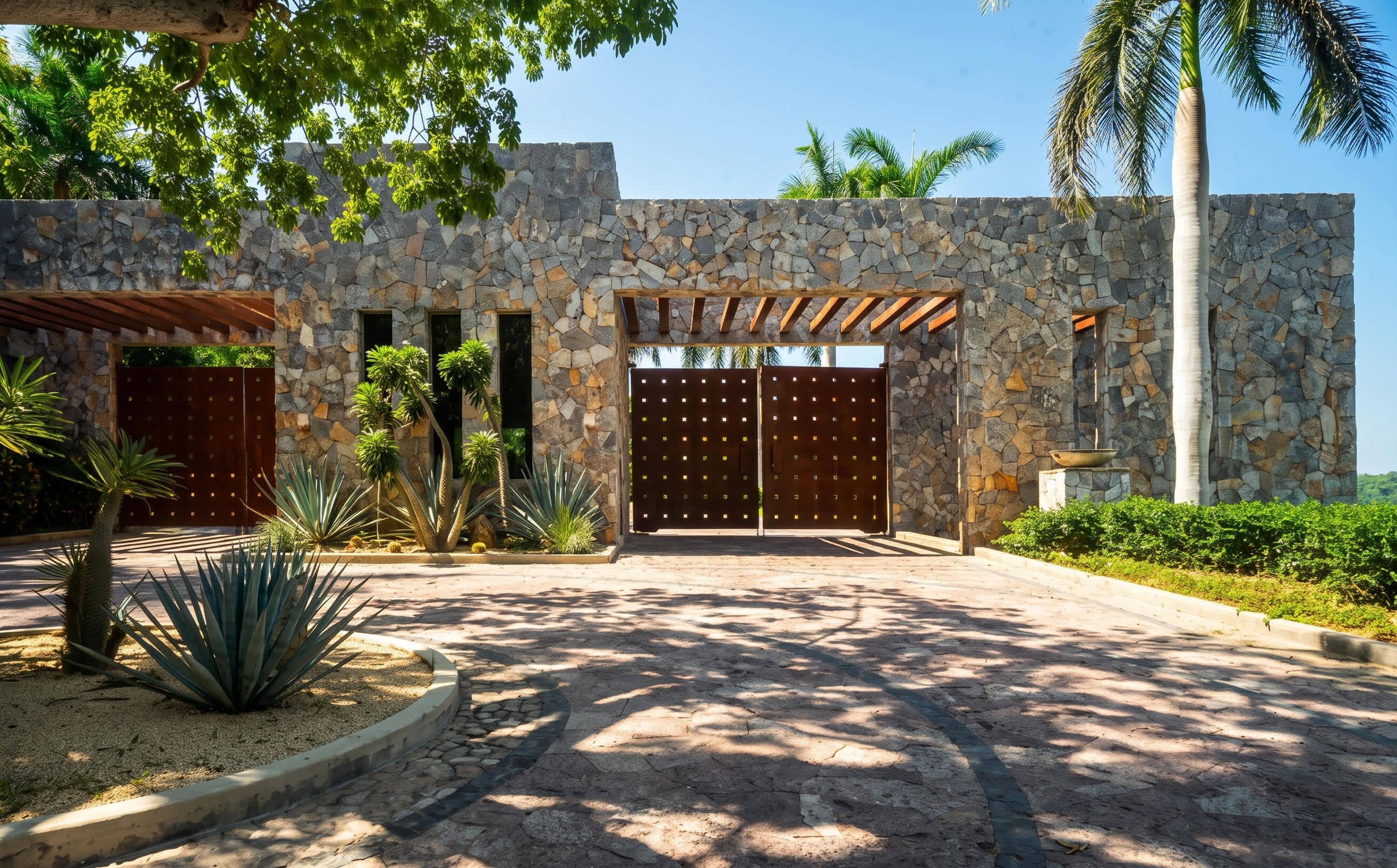 A stone building with a gated entrance, palm trees, and a pergola.