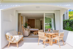 An open-plan living area with a sofa, dining table, and chairs. - New Listing (anse marcel)