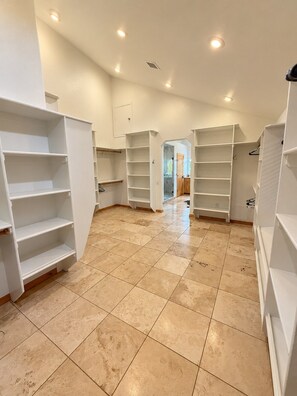 A spacious room with multiple white shelving units and a tiled floor. - Mountain Meadow Ranch Private 5-Acre Escape (Parks)