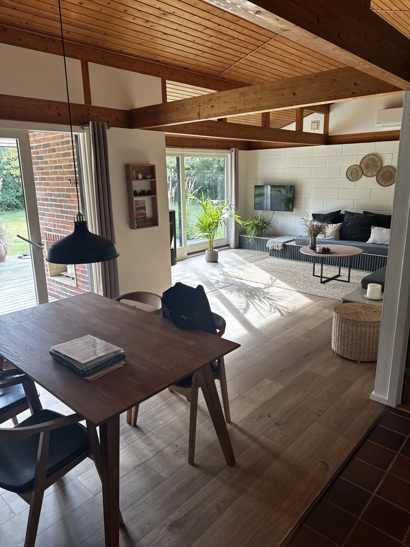 A modern interior with a dining area, a kitchen, and a living space.