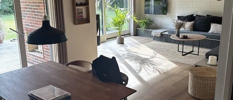 A modern interior with a dining area, a kitchen, and a living space.