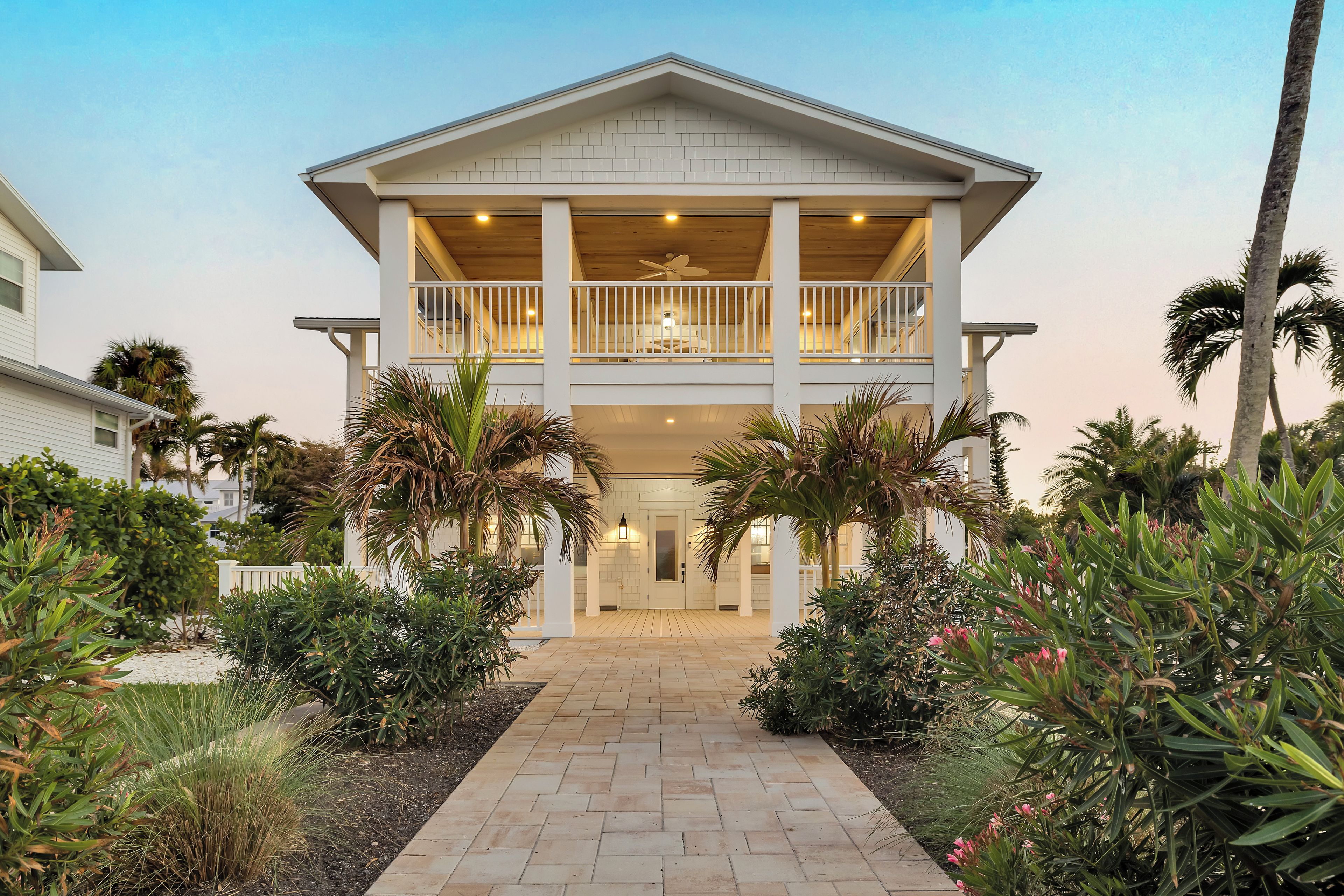 A two-story building with a central entrance, a covered porch, and a balcony on the upper floor.