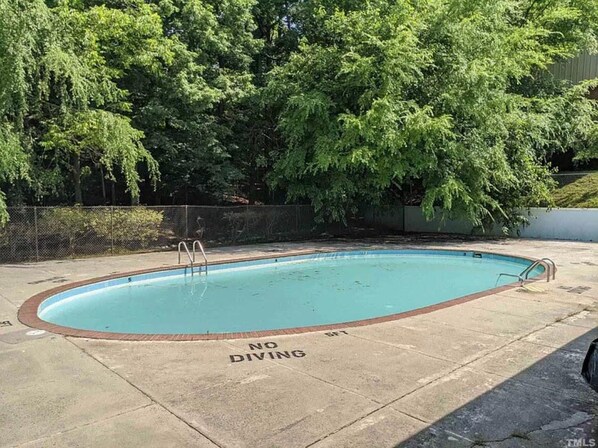 A swimming pool with a 'NO DIVING' sign on the edge.