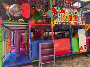 A colorful indoor play area with a sign reading 'Diverti Hacienda.' - Hotel Boutique Santa Teresa (San Andrés Cholula, Puebla)