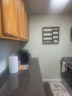 A kitchen with wooden cabinets, a coffee maker, a paper towel holder, and a towel rack. - 3 bdrm house! Unbeatable Location! Close to Everything: Wind Rock, Melton Hill! (Clinton)