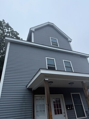 A two-story house with a front porch, a garage door, and a mailbox. - Spacious 2 bedroom sanctuary in the heart of Fitchburg (Fitchburg)