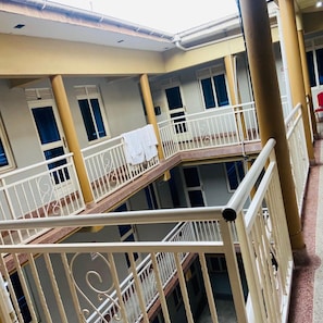 A multi-level building with balconies, railings, and windows. - Pearl Express Hotel Kabale (Kabale)