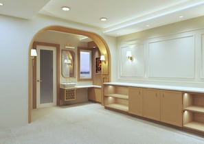 A hotel bathroom with a vanity, mirror, and wall-mounted lights. - Aryan Inn Hotel (Varanasi)