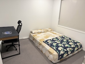 A small, neatly arranged bedroom with a bed, a desk, and a chair. - Spacious Private Bedrooms in Shared House (Morayfield)