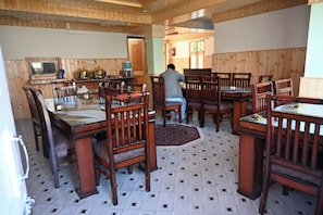 A dining area with wooden furniture and a tiled floor. - Snow Lotus Kalpa (Jangal Mehfuza Mehduda C-)