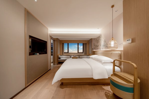 A modern hotel room with a large bed, a television, a wall-mounted heater, and a view of the sky through the window. - QI YUE Song yin Hotel (Hangzhou)