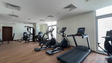 A gym with treadmills, elliptical machines, and weight equipment.