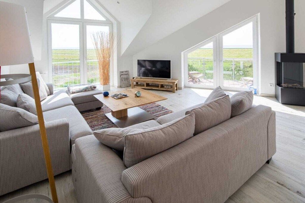 A modern living room with a sofa set, a coffee table, and a television.