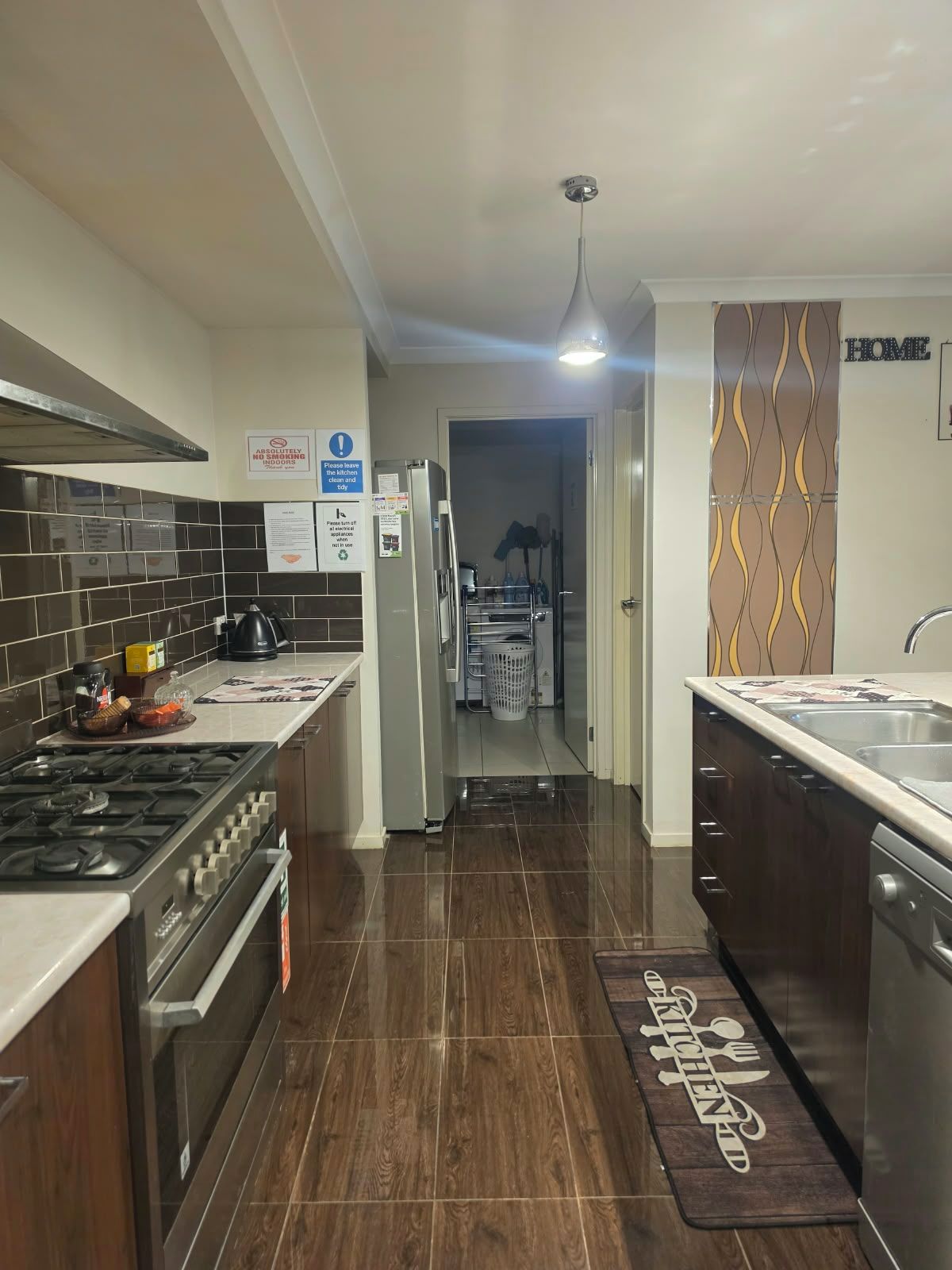 A modern kitchen with a gas stove, stainless steel appliances, and a patterned backsplash.