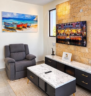 A modern hotel lobby with a bar area, a reclining chair, and a marble coffee table. - Modern Comfort Villa  (Mombasa)