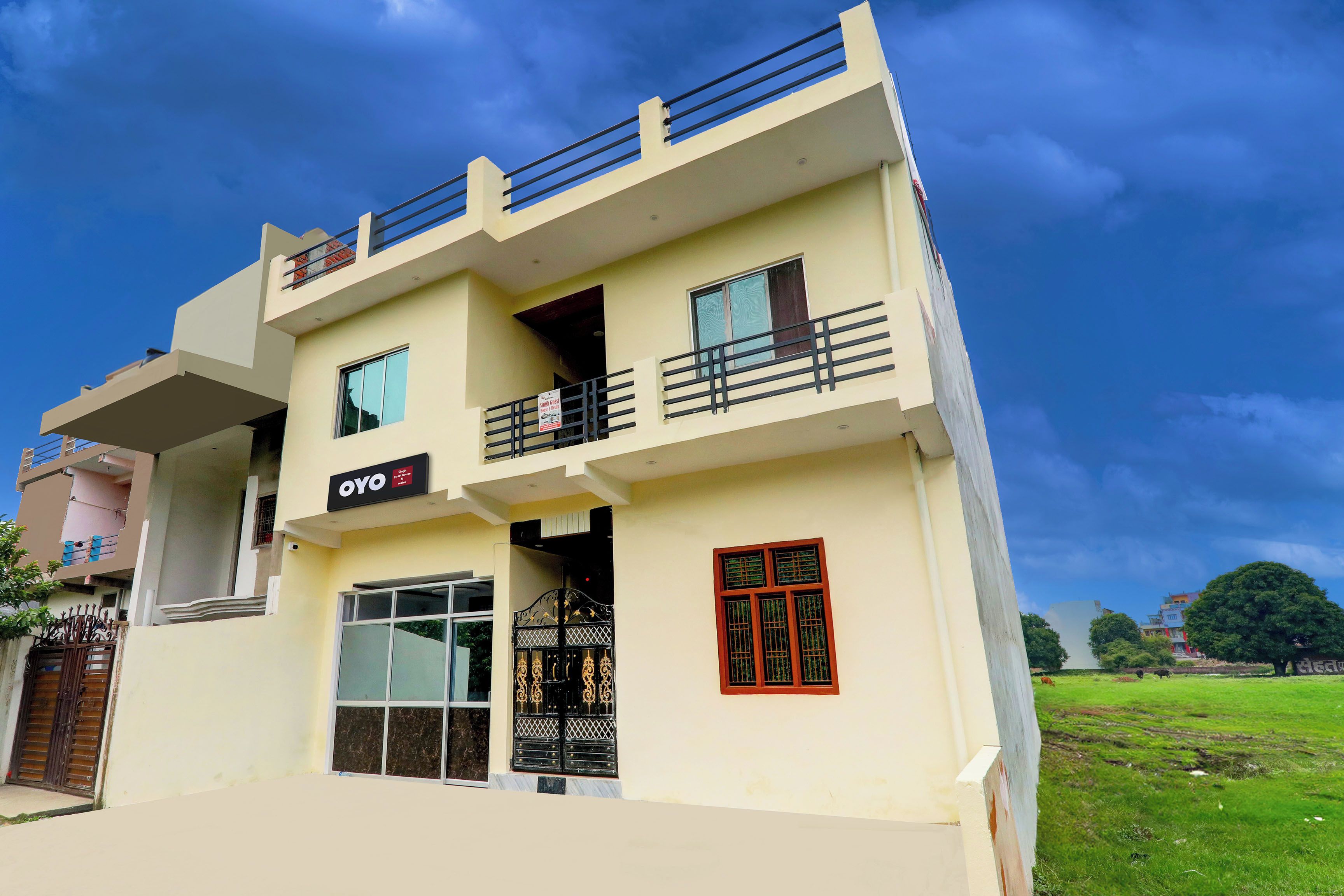 A two-story building with a sign for 'OYO' indicating a hotel or guesthouse.