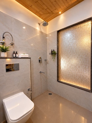 A modern bathroom with a shower, toilet, and a decorative tiled wall. - Hotel Old Manali Retreat (Manali)