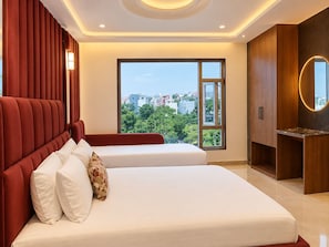 A hotel room with a large bed, a smaller bed, a vanity with a mirror, and a view of the city. - Hotel Benchmark Suites (indore)