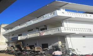 A multi-story building with balconies and a ground-level entrance. - Hotel O by OYO Siddharth Hotel And (Goshainganj)