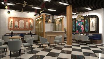 Restaurante com piso xadrez, vários espaços de assento e decoração nas paredes.