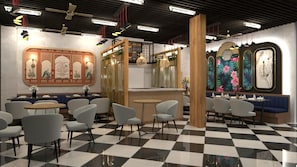 Restaurante com piso xadrez, vários espaços de assento e decoração nas paredes.