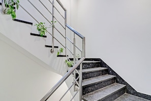 Eine Treppe mit Metallgeländern und Blumentöpfen.