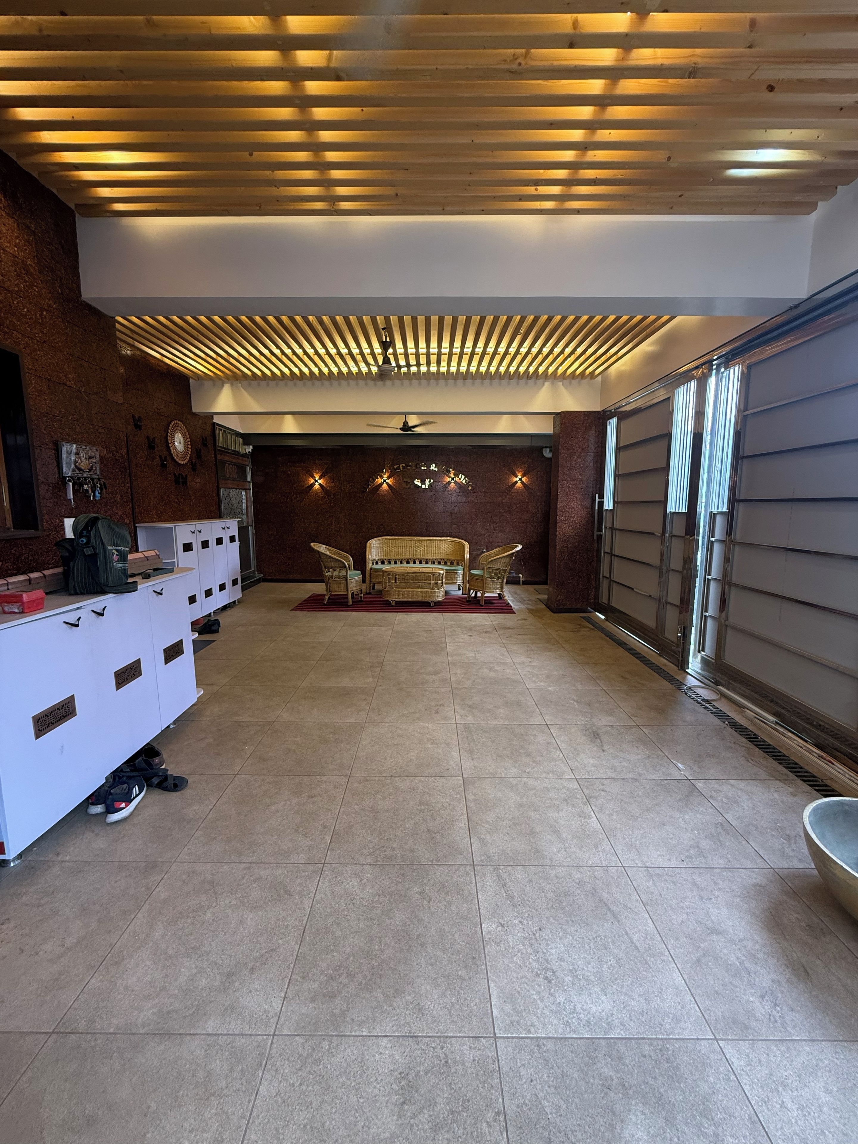 A spacious lobby with a reception desk, seating area, and a large window.