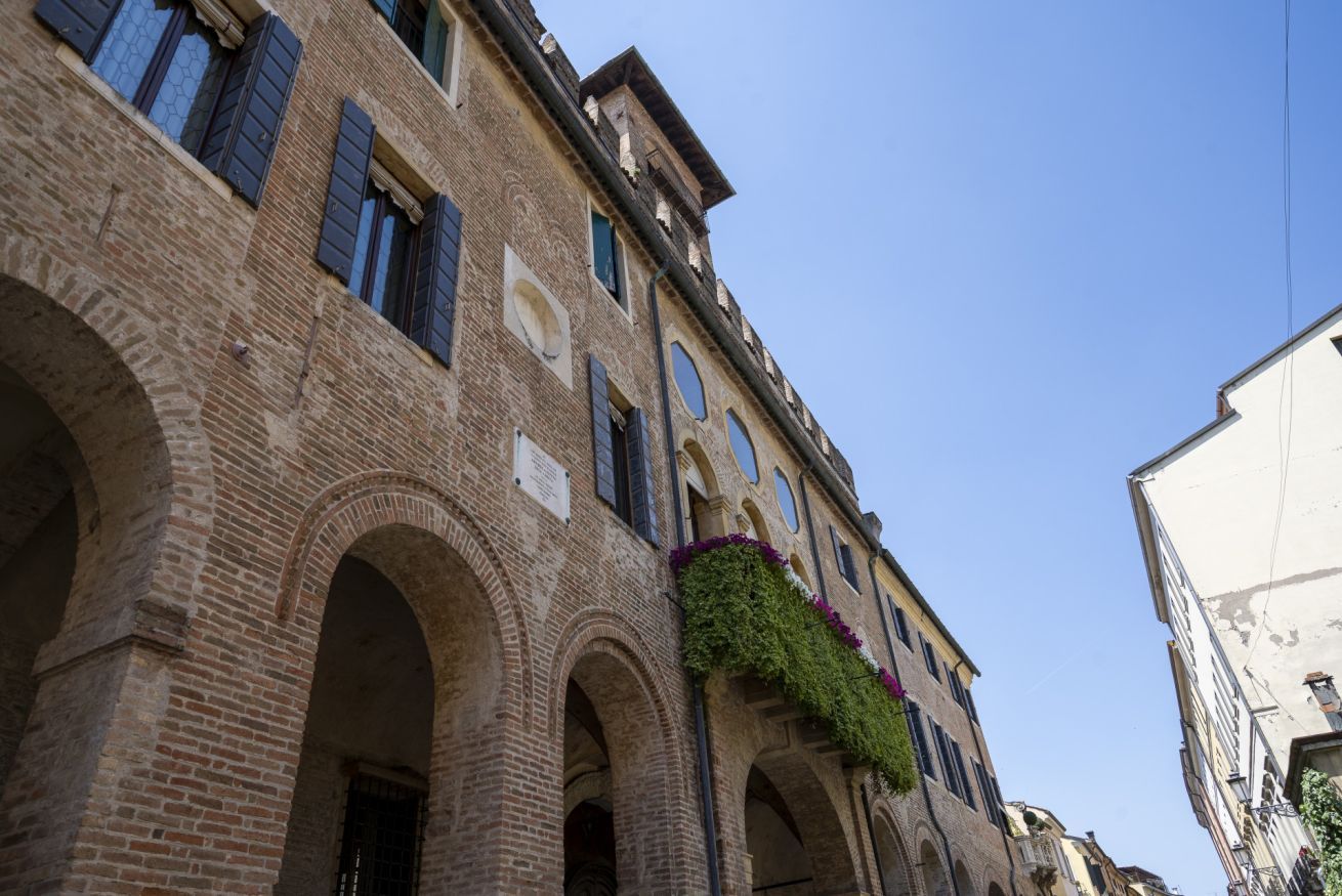 A historic building with arched windows and brickwork.