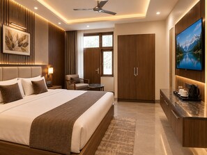 A modern hotel room with a large bed, a desk with a coffee maker, a TV, and a wardrobe. - Hotel Radhe Elite At Delhi Airport  (New Delhi)