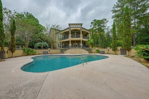 A two-story building with a swimming pool in front.