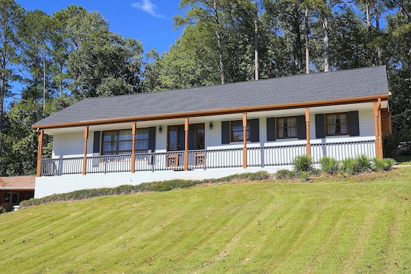 A two-story building with a covered porch and a brick exterior.