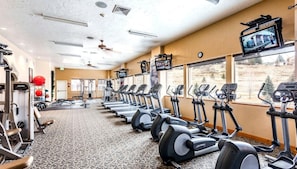 Ein Fitnessstudio mit Laufbändern, Kraftgeräten und Trainingsbällen.