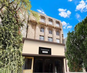 A multi-story building with a sign reading 'TOWNHOUSE Company Serviced.' - Super Deluxe Room Hotel Roopali (Jabalpur)