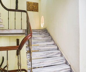 A staircase with marble steps and wooden balusters. - Super Deluxe Room Hotel Roopali (Jabalpur)