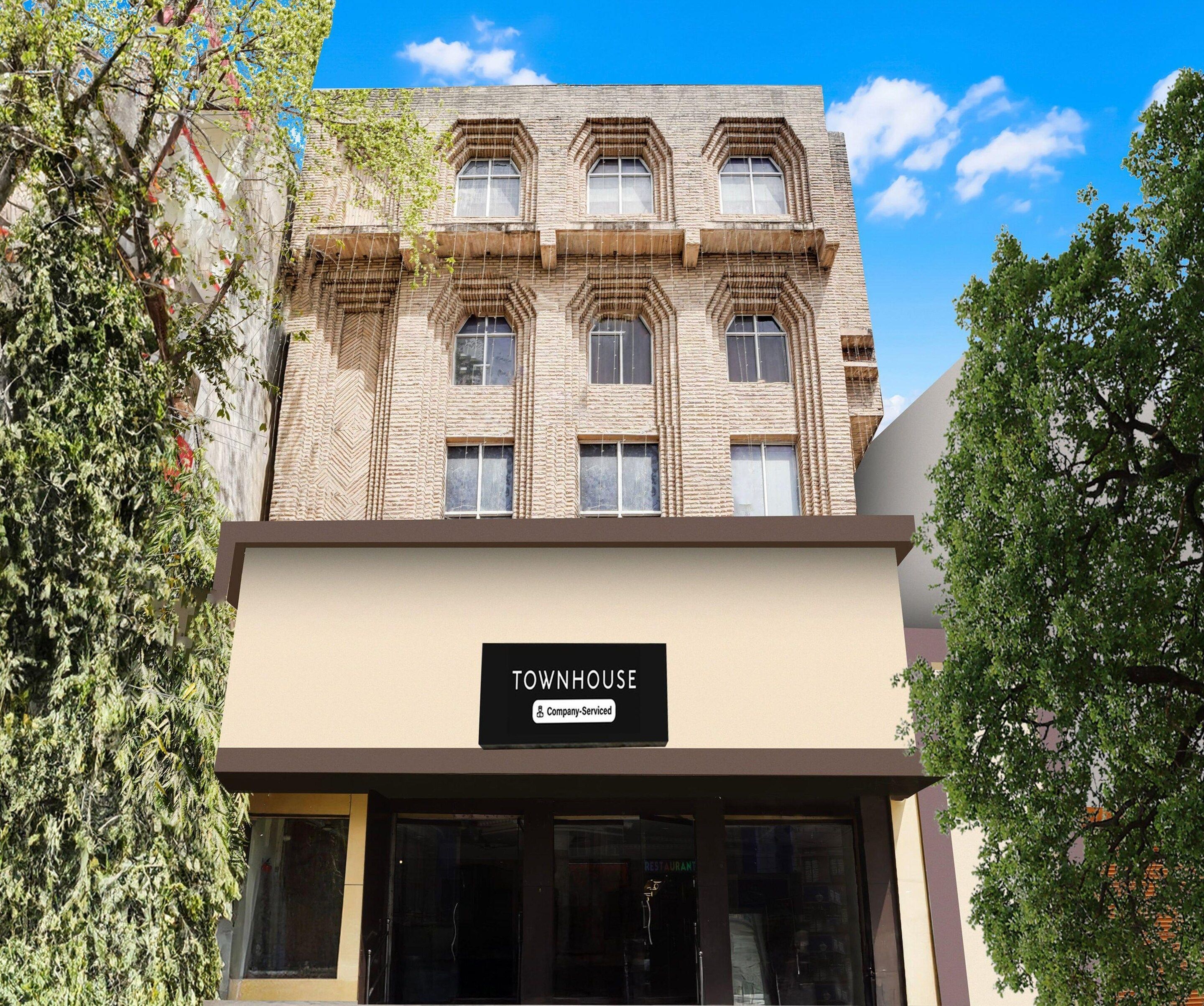 A building with a sign reading 'TOWNHOUSE' and a 'Company-Serviced' label.